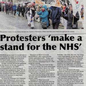 Presscutting: Picture protesters with banners in the rain, Penzance. "Protesters make a stand for the NHS. People across West Cornwall took to the streets in a wave of action to support the NHS starting ath the most south-westerly tip [St Just] of the country up to Truro..." Cornwall Live